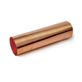 Cylindrical piece of copper metal on a white background